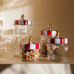 Alessi Jar with hermetic lid Circus Rasia MW3-100 in varying sizes, featuring colorful circus-themed lids.