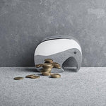 Georg Jensen Moneyphant säästölipas 3580035, tyylikkäänä elefanttimuotoisena säästölippaan kanssa kolikoita.